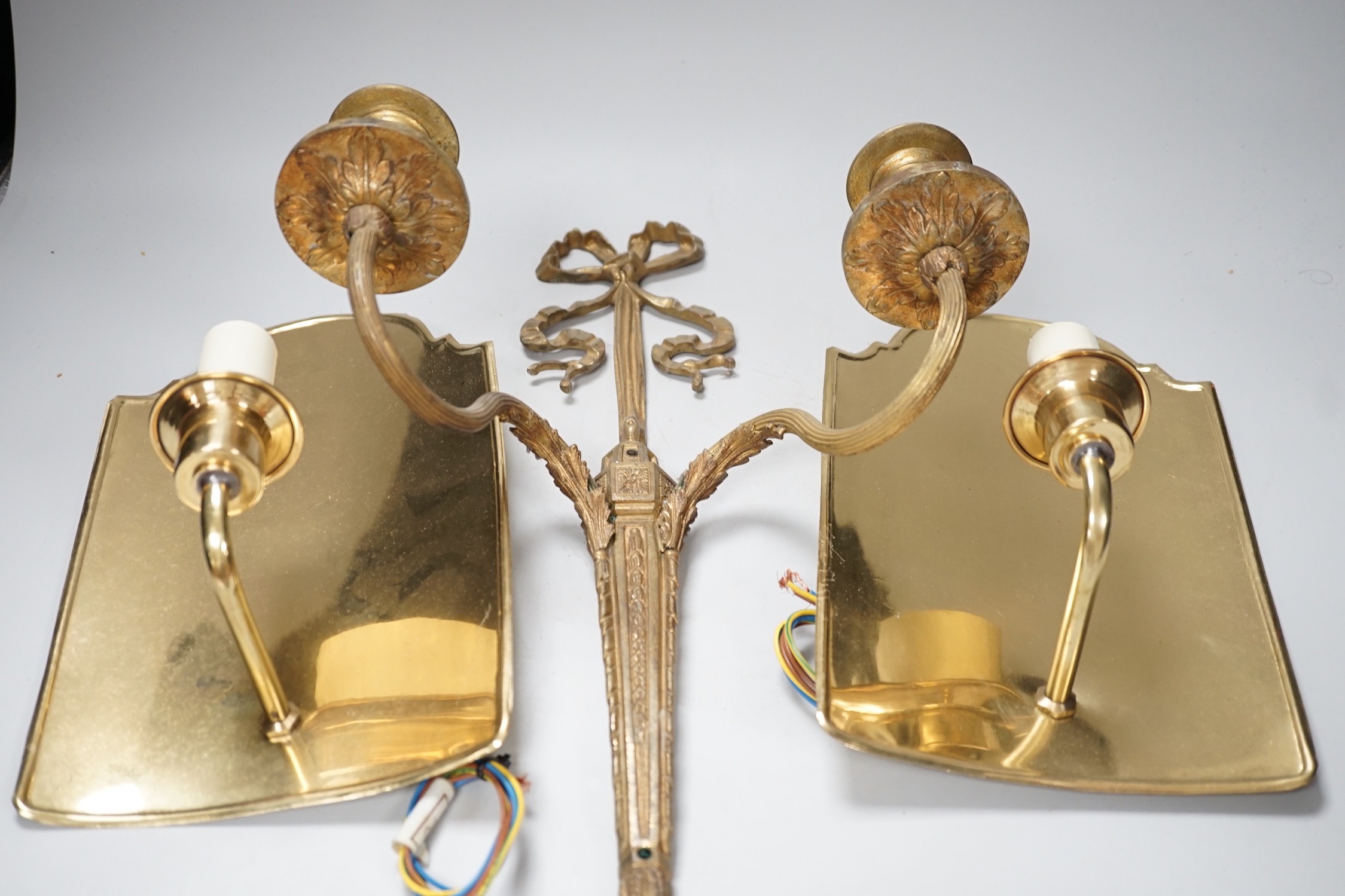 An 18th century style ribbon design brass two branch wall sconces and a pair of Dutch style brass wall lights, tallest 44cms high